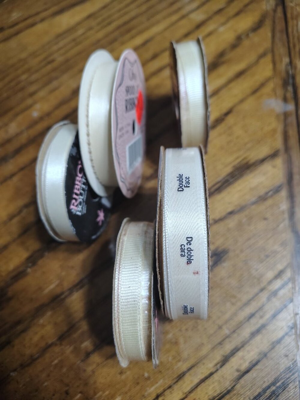 assortment of five different cream color ribbons